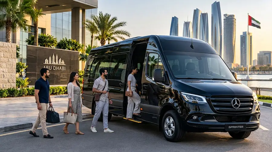 Group of tourists boarding a luxury black Mercedes Sprinter van parked in front of the Abu Dhabi city skyline.