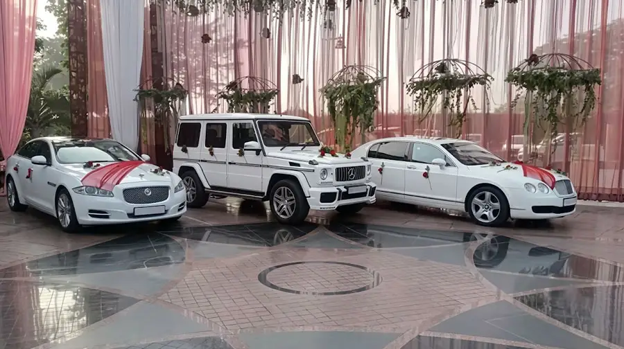 Three decorated white luxury cars for a wedding in Abu Dhabi.