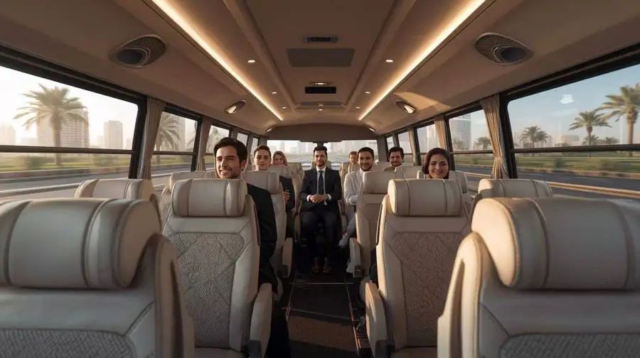 Spacious minibus interior with comfortable leather seats and passengers seated, chatting and enjoying the ride.