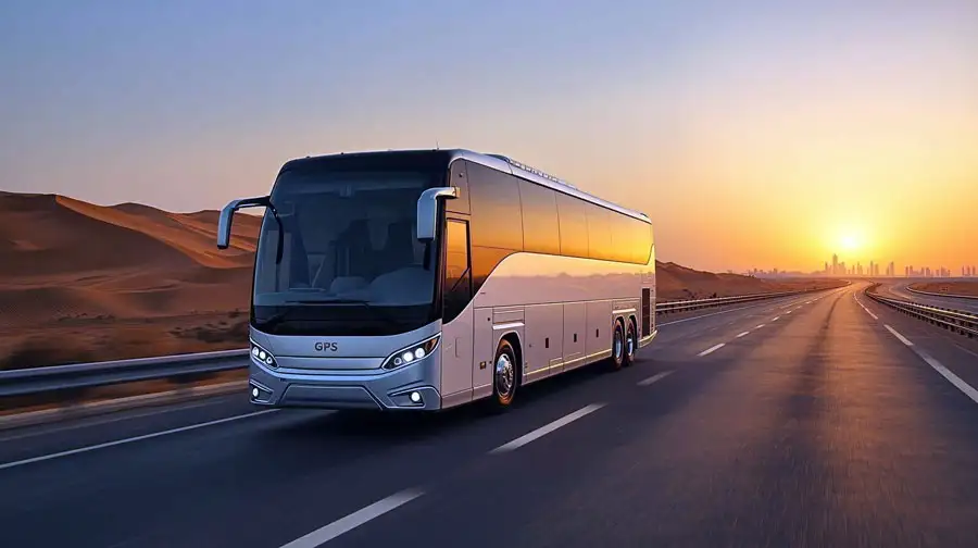 Luxury bus traveling on the highway between Dubai and Abu Dhabi during sunset with desert landscape.